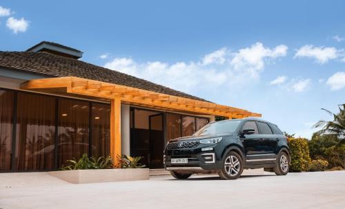 a black car parked in front of a house at AnoMansa Beach Resort at Elmina Bay in Elmina