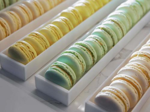 a row of macaroons lined up on a table at Sofitel Legend Casco Viejo, Panama City in Panama City