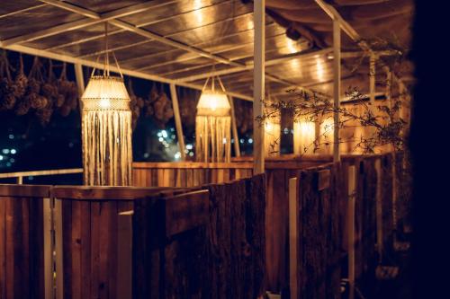 a row of chandeliers hanging over a wooden bar at Windy Hill Hotel And Restaurant in Bungmati
