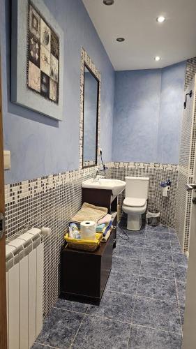 a bathroom with a sink and a toilet at Casa de piedra, A Lameira in A Coruña