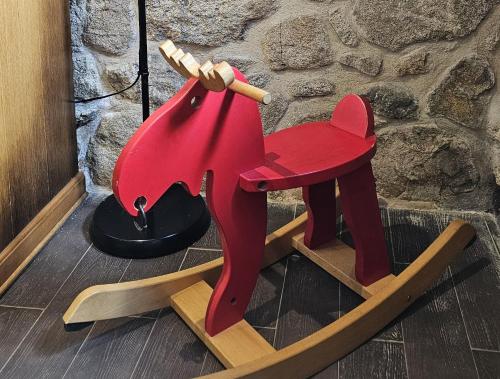 a wooden rocking horse on a wooden sled at Casa de piedra, A Lameira in A Coruña