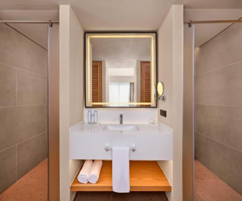 a bathroom with a sink and a mirror at Paloma Grida in Belek
