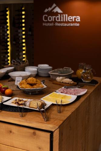 a wooden table with food on top of it at Hotel Cordillera in El Bolsón