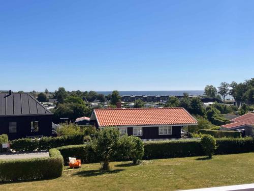 a house with a red roof in a yard at Cozy Holiday Home Just 200 M From Beach in Kerteminde