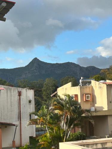 a view of a building with a mountain in the background at Lovely home in Ebene with beautiful views in Ebene