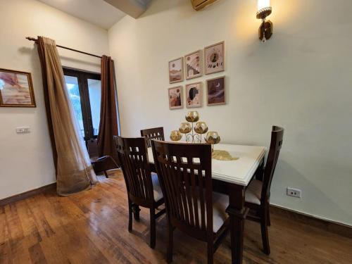 a dining room with a table and chairs at Cocoa Bliss in Manesar