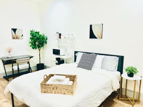 a bedroom with a bed with a basket on it at Modern New Studio Cozy&Prime Location in North Sherman Way