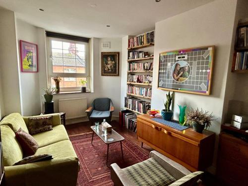 a living room with a couch and a table at Open plan stylish urban flat in London