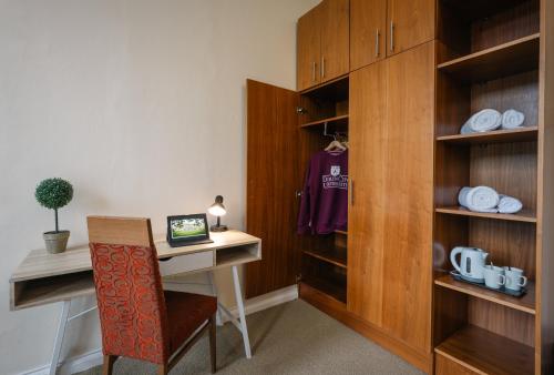 a room with a desk and a table and a chair at DCU Rooms All Hallows in Dublin