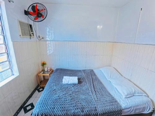 a bedroom with a bed with a blue comforter at QUANG'S nhà nghỉ in Thôn Kim Long (1)