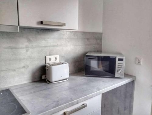 a kitchen counter with a microwave and a toaster at 1 Zimmer Apartment in Wuppertal