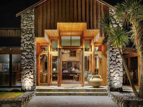 a house with a large glass door with a table at Fable Terrace Downs Resort by MGallery in Windwhistle