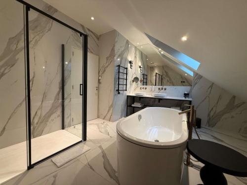 a bathroom with a toilet and a shower and a sink at La Licorne Hotel & Spa Troyes - MGallery Collection in Troyes
