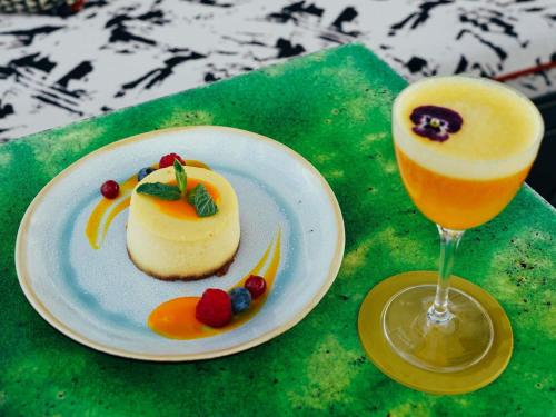 a table with a plate of dessert and a drink at Too Hotel & Spa Paris - MGallery Collection in Paris
