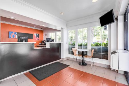 a living room with a table and a television at Motel 6-San Jose, CA - Convention Center in San Jose
