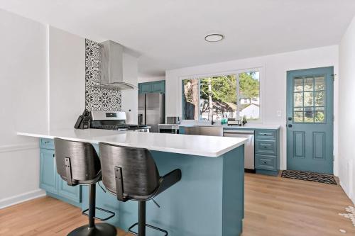 a kitchen with blue cabinets and white counter tops at Fire pit ~ Game Room ~ near NYC ~ Modern Luxury in New Rochelle