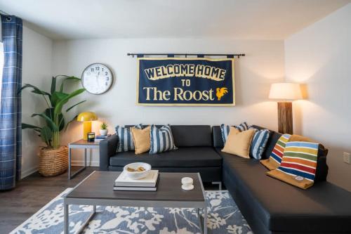 a living room with a couch and a clock at New Modern Comfort with Pool and Clubhouse in Burnside East