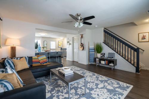 a living room with a couch and a table at New Modern Comfort with Pool and Clubhouse in Burnside East