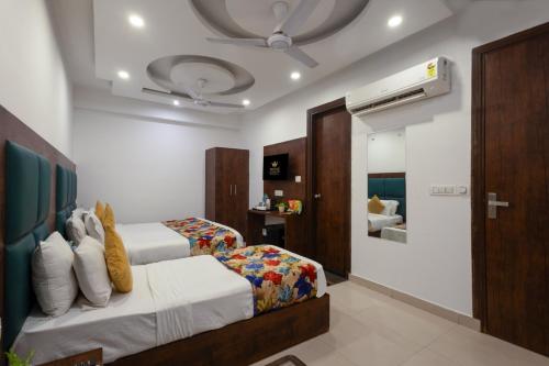a hotel room with a bed and a bathroom at Hotel Grand TELA plaza Near IGI Airport Delhi in New Delhi