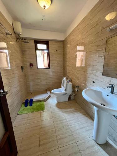 a bathroom with a toilet and a sink at Coastal bliss apartment in Mombasa