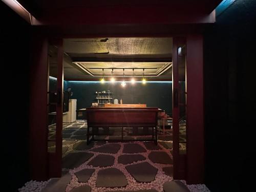 a dark room with a piano and a room with a rug at Dal Dam, a pet-friendly accommodation in the west of Jeju, a private underground bunker event room for family groups in Ŭmbu-dong