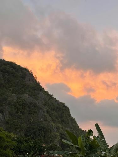 a mountain with a sunset in the background at Tuan Nam Homestay in Ninh Binh