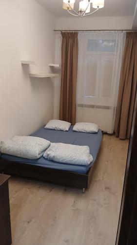due letti in una stanza con una finestra di Accordo WP a Świętochłowice