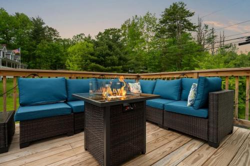 a patio with a blue couch and a table at Upstate NY Escape - Game Ready, Game Room, Pool Table, Firepit, Delaware River in Sparrow Bush