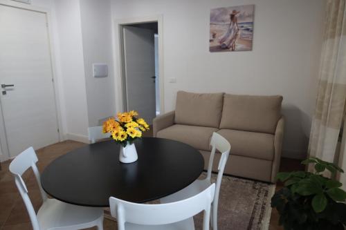 a living room with a table and a couch at Podere La Saliciaia in Monsummano