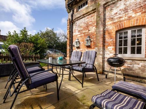 a patio with a table and chairs and a brick building at 1 bed in Beaulieu 53042 in Beaulieu