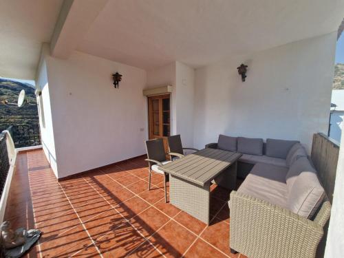 a living room with a couch and a table at The Retreat, Alcazar in Órgiva