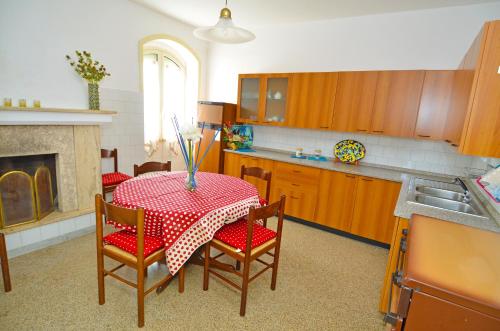 a kitchen with a table with a red and white table cloth at Salento Home Collection 03 - Marina di Pescoluse in Marina di Pescoluse