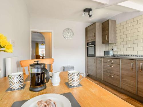a kitchen with a table with a coffee pot on it at 2 Bed in Reepham 85833 in Cawston
