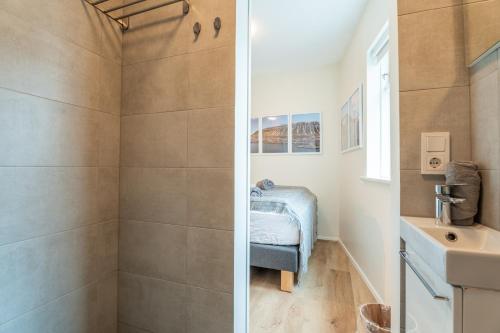 a bathroom with a shower and a sink at The Ísafjörður Inn by Ourhotels in Ísafjörður