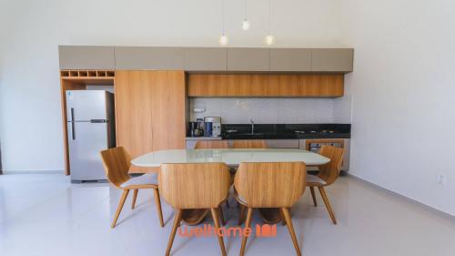 a kitchen with a table and chairs in a kitchen at Casa em Marechal Deodoro com jacuzzi in Marechal Deodoro