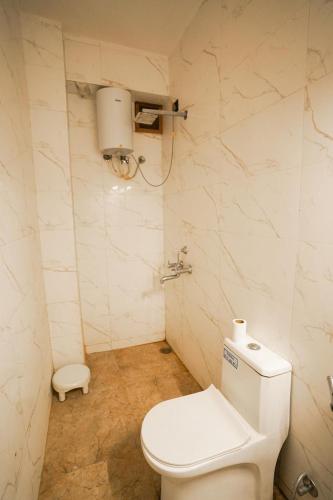 a bathroom with a white toilet in a room at Thar Tribe Hostel Jaisalmer in Jaisalmer