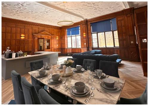 a large dining room with a table and chairs at 16 Queen Avenue Collection by Happy Days in Liverpool