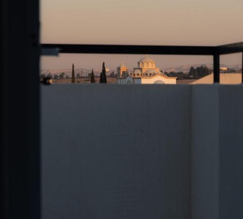 a view of a city from behind a wall at TelMar duplex in Livadhia