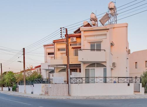 an apartment building with antennas on top of it at TelMar duplex in Livadhia