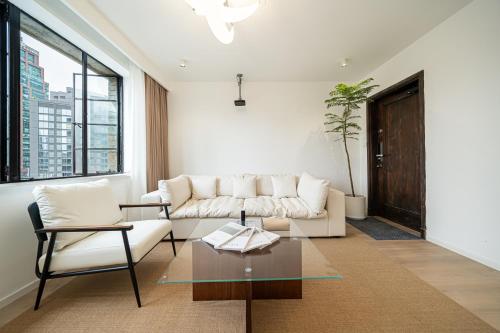 a living room with a couch and a table at Tonight Homestay West Nanjing Road Shanghai in Shanghai