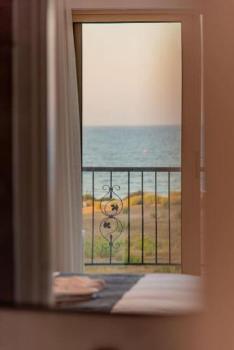 a view of the ocean from a window of a room at TelMar Royal Villa Sea View in Mazotos