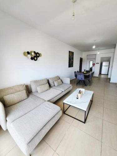 a living room with a couch and a table at telMar city in Larnaka