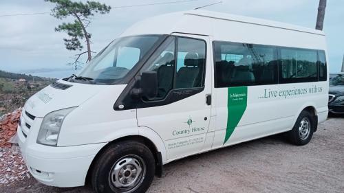 a white van parked on the side of a road at INN Mountain Country House in Caniço