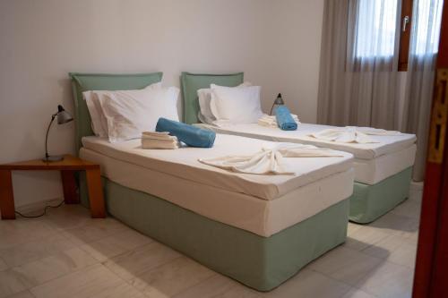 two beds sitting next to each other in a room at Terra Ionian in Áyios Ilías