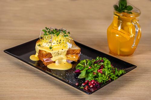 a black plate with a piece of bread with cheese at Penzión Arizona in Zlaté Moravce