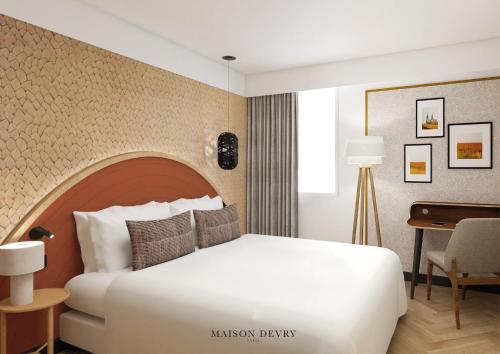 a bedroom with a large white bed and a desk at Mercure Chartres Est in Chartres