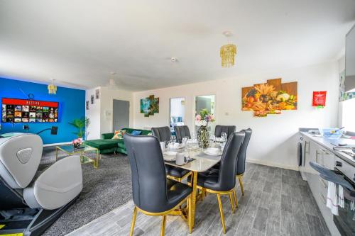 a dining room with a table and chairs at F1TR Luxurious & Comfy Stay in Batley
