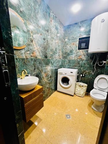 a bathroom with a sink and a toilet and a sink at Bakhmaro Mountains in Chʼkhakoura