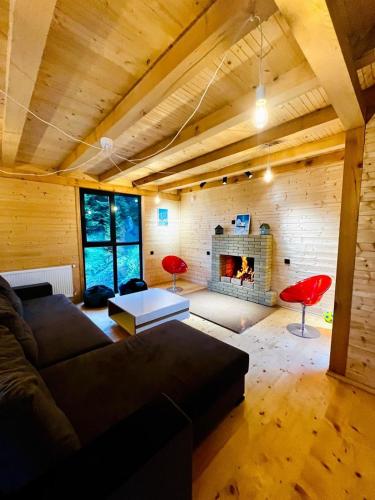 a living room with a couch and a fireplace at Bakhmaro Mountains in Chʼkhakoura