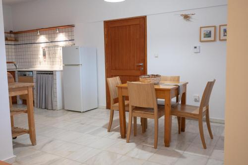 a kitchen and dining room with a table and chairs at Terra Ionian in Áyios Ilías